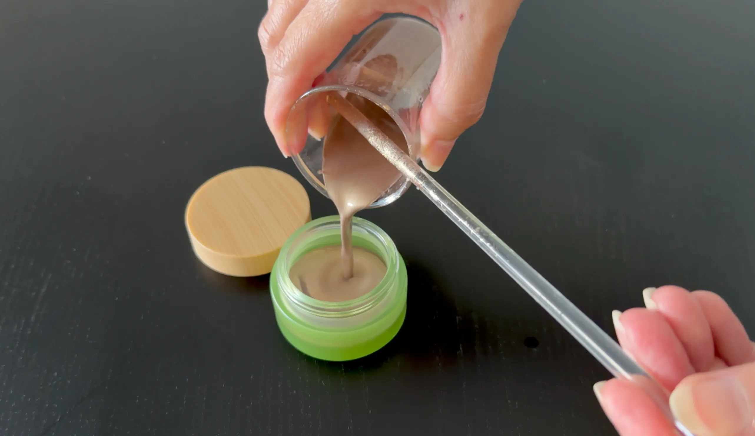 Pouring the eyeshadow into the jar