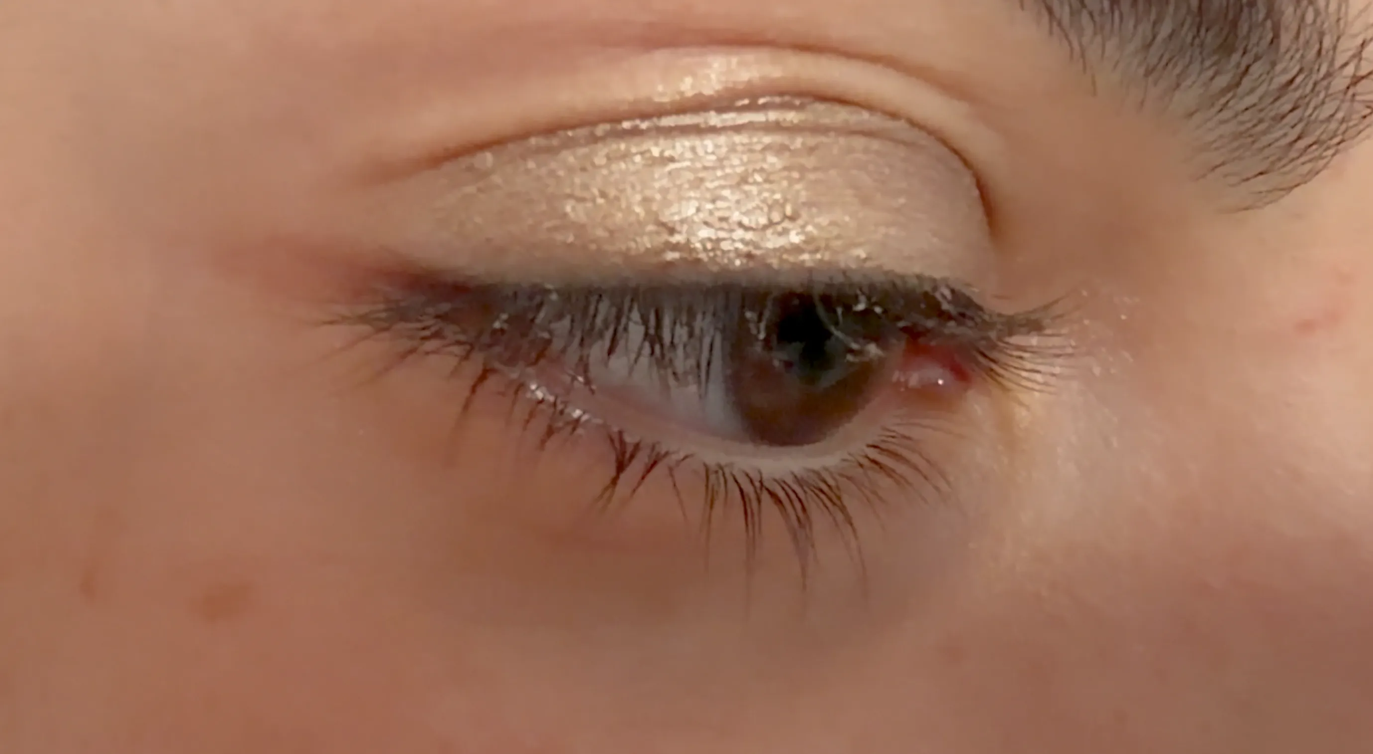 A creamy, shimmering homemade eyeshadow in a custom golden shade
